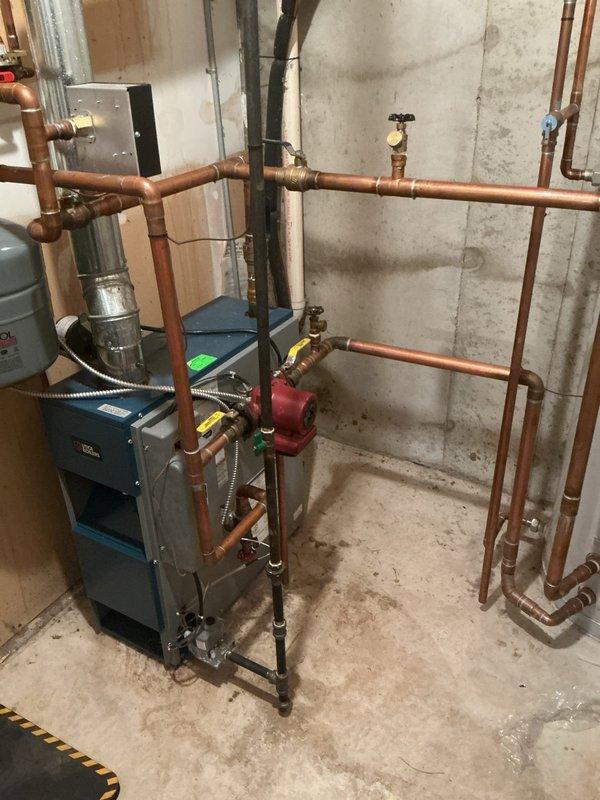 Completed annual cooling system maintenance on 13-year-old EnergiAir unit with condenser model year 2020. Performed standard tune-up procedures including system inspection, operational testing, and documentation with photos of hydronic heating system and associated mechanical components in basement utility area.