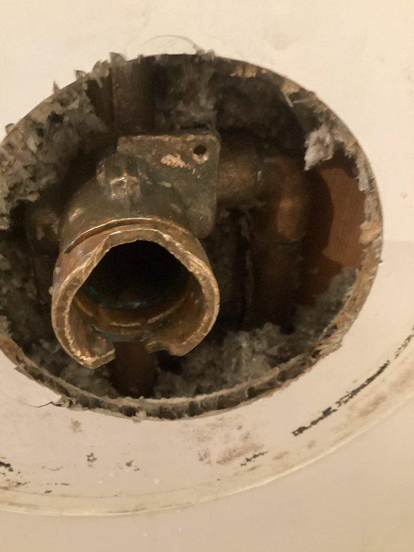 Responded to service call for shower handle that would not activate water flow. Upon inspection, accessed the valve assembly through the wall opening and found severely corroded shower valve components with significant age-related deterioration. Replaced the faulty valve cartridge and tested the handle operation to confirm proper water flow restoration. System returned to full working order with smooth handle operation and adequate water pressure.