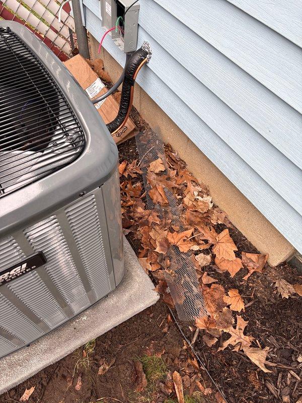 Completed full air conditioning system installation at residential property. Installed new outdoor condensing unit on concrete pad at side of house with proper clearances, mounted electrical disconnect box on exterior wall, and ran refrigerant line set with protective conduit to indoor air handler. Interior installation included air handler placement in utility room with electrical connections, condensate drain line installation, and integration with existing ductwork. System tested and verified operational with proper refrigerant charge, airflow, and electrical connections. All electrical work completed to code with proper disconnect and circuit protection. Financing paperwork processed and activated.