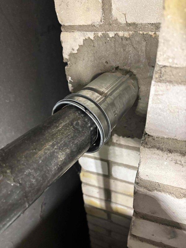 Responded to inspector correction notice requiring chimney liner installation. Documented existing chimney structure in attic space showing brick construction without proper liner system. Photographed current conditions including chimney penetration through roof framing and attic access point to support permit amendment and reinspection scheduling.