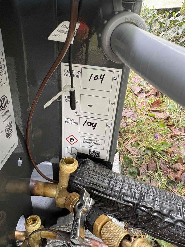 Completed installation of new air conditioning system including outdoor condensing unit with proper refrigerant charge (164 oz factory charge, 104 oz total charge documented on unit label). Installed copper refrigerant lines with brass service valves, PVC condensate drainage, electrical disconnect, and connected all necessary piping and wiring. System tested and verified operational per manufacturer specifications.
