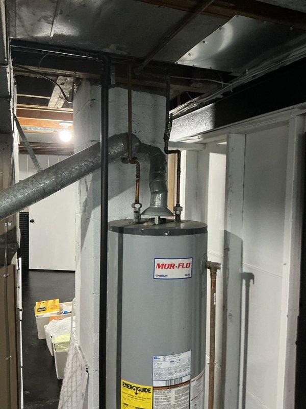 Completed water heater estimate for existing MOR-FLO unit located in basement utility area. Assessed current installation including supply and discharge piping connections, shut-off valves, and venting configuration. Documented equipment specifications and provided replacement options for client consideration.