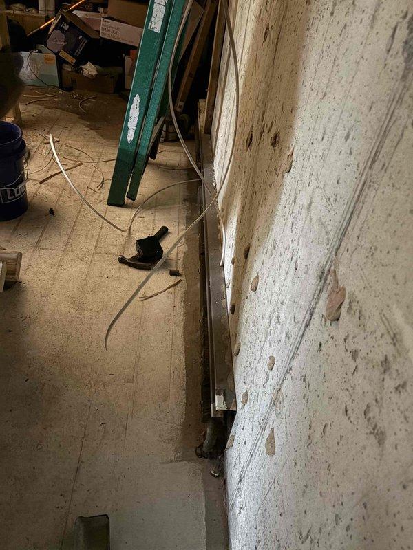 Removed existing baseboard heater from basement wall and properly capped supply and return lines in preparation for room remodeling. Measured and documented wall dimensions for future heater reinstallation once finish work is completed.