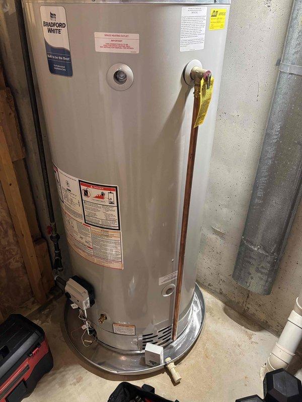 Responded to water heater alarm activation on a Bradford White unit with warranty expiring 08-2026. Upon inspection, investigated reported slight leak concern and conducted thorough visual examination of the unit and surrounding plumbing connections. Inspected copper supply lines, brass fittings, temperature and pressure relief valve discharge piping, and all visible connections for signs of moisture or active leakage. Documented current condition of water heater installation including all safety labels, control components, and proper venting configuration with photographic evidence for warranty and service records.