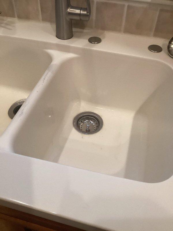 Responded to a drain service call for a bathroom sink. Upon inspection, found the sink draining properly with all plumbing components functioning correctly. The P-trap assembly under the sink was clean and properly configured with no visible leaks or blockages. Verified drain operation, confirmed the pop-up drain assembly and strainer basket were clear of debris, and ensured the overflow drain was unobstructed. All connections were secure and the plumbing system was operating as designed.