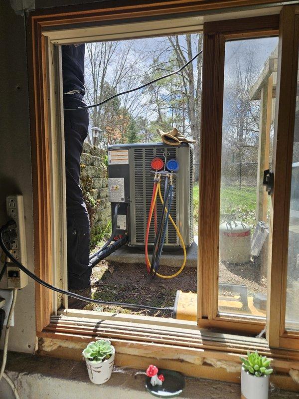 Completed full HVAC system replacement including new furnace and air conditioning unit. Installed modern furnace with matching evaporator coil in basement mechanical room, configured all PVC condensate drain lines and venting pipes, connected black flexible ductwork to existing distribution system, and mounted equipment on protective pad. Installed new outdoor condensing unit in backyard, ran refrigerant lines through window opening, completed all electrical connections including conduit installation, and performed system startup with refrigerant charging using manifold gauges. Verified proper operation of both heating and cooling systems.