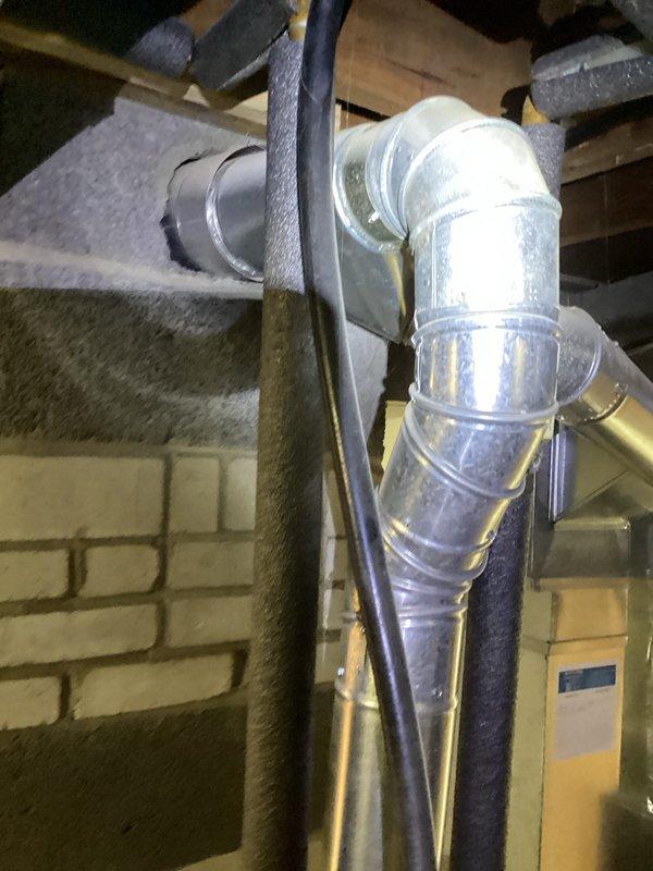 Responded to water leak complaint on 12-year-old water heater that was still producing hot water. Upon inspection, identified Bradford White water heater with active leak. Documented equipment condition and installation setup, including venting configuration and surrounding HVAC components in basement mechanical room. Photographed water heater, exhaust flue system, and overall equipment layout to assess leak source and determine repair or replacement recommendations for client consideration.