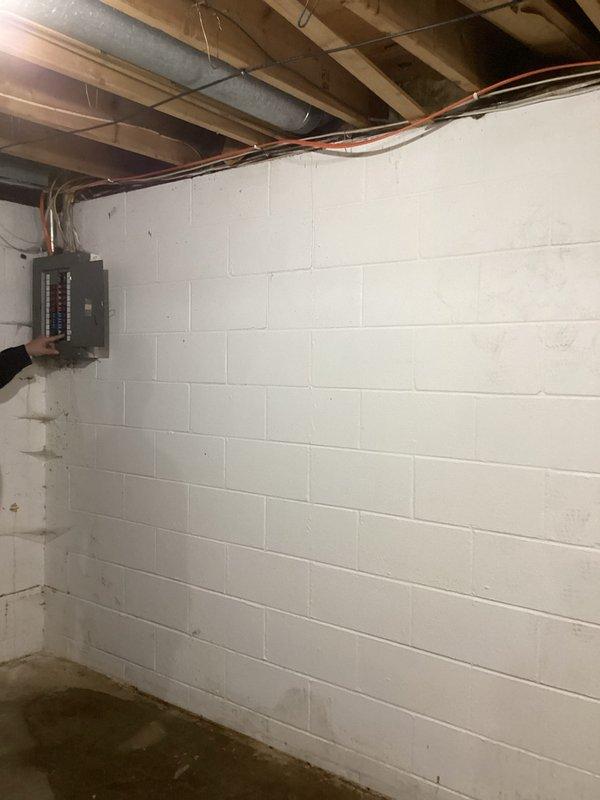 Completed electrical estimate for panel upgrade at 50-year-old residential property. Assessed existing electrical service including basement-mounted circuit breaker panel with multiple conduits and exterior digital utility meter with associated service entrance conductors. Documented current electrical infrastructure conditions and photographed panel location, service entrance equipment, and meter installation to provide comprehensive upgrade proposal for aging electrical system.