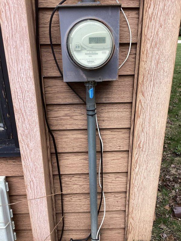 Completed electrical estimate for panel upgrade at 50-year-old residential property. Assessed existing electrical service including basement-mounted circuit breaker panel with multiple conduits and exterior digital utility meter with associated service entrance conductors. Documented current electrical infrastructure conditions and photographed panel location, service entrance equipment, and meter installation to provide comprehensive upgrade proposal for aging electrical system.