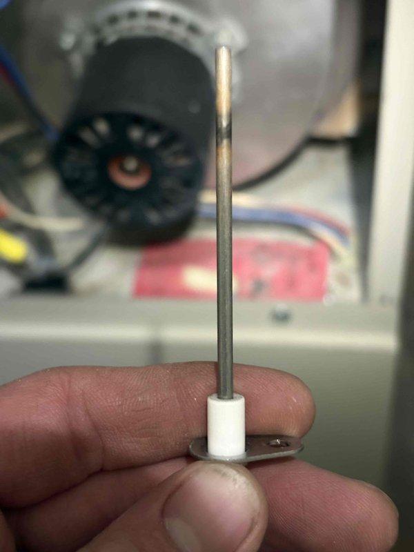 Responded to no heat call on 21-year-old Nordyne furnace. Found flame sensor had detached from mounting bracket due to frayed and broken wire connection, causing system failure. This flame sensor has required multiple previous replacements due to environmental conditions affecting component longevity. Documented failed component condition with photos showing deteriorated wiring and displaced sensor rod. Customer advised that recurring failures are attributed to environmental factors within the system.