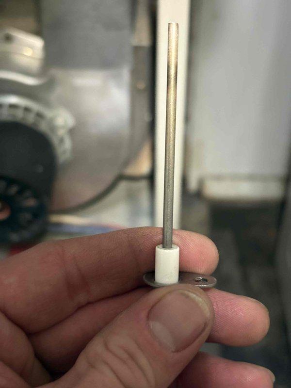 Responded to no heat call on 21-year-old Nordyne furnace. Found flame sensor had detached from mounting bracket due to frayed and broken wire connection, causing system failure. This flame sensor has required multiple previous replacements due to environmental conditions affecting component longevity. Documented failed component condition with photos showing deteriorated wiring and displaced sensor rod. Customer advised that recurring failures are attributed to environmental factors within the system.