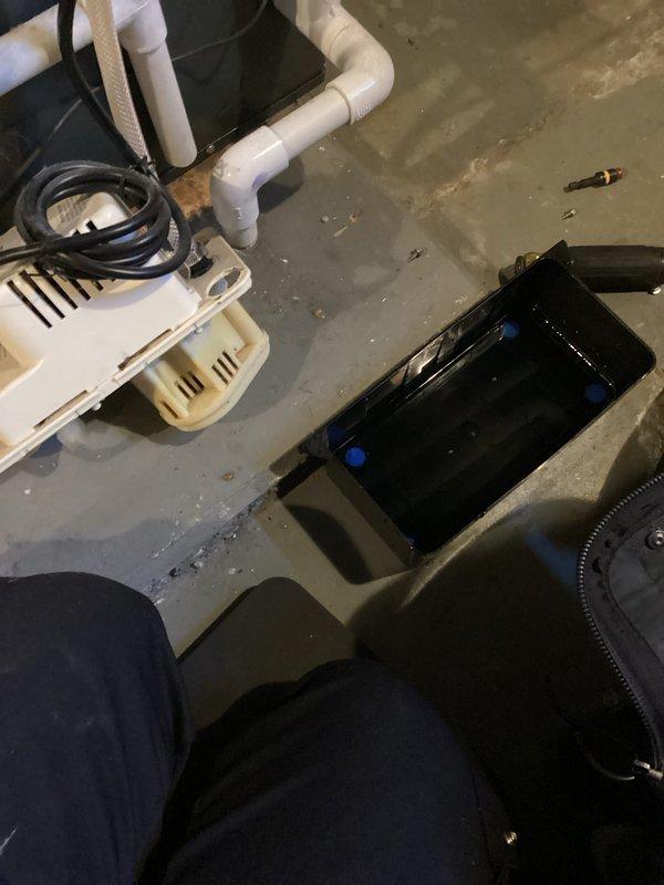 Completed annual cooling system tune-up on EnergiAir unit under 5-year warranty coverage. Inspected condensate drainage system including pump assembly, drain pan, and associated plumbing connections; noted brownish water accumulation in pan indicating normal condensate flow with possible minor sediment buildup. All components photographed and documented for warranty maintenance records.