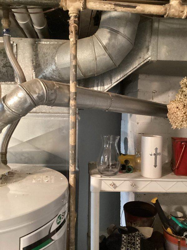 Completed comprehensive furnace super tune-up on 13-year-old Carrier unit. Performed full system inspection, cleaned and tested all components, verified proper operation of heating system, and documented equipment condition with photos showing HVAC ductwork, water heater connections, and mechanical room infrastructure.