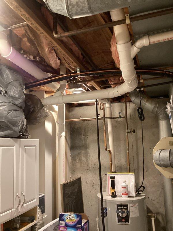 Completed full air conditioning system installation in basement utility area. Installed new outdoor condensing unit on concrete pad with proper refrigerant line connections, service ports, and electrical hookup. Connected system to existing ductwork infrastructure with appropriate flex duct transitions and verified all mechanical connections, refrigerant lines, and drainage systems are properly secured and operational.