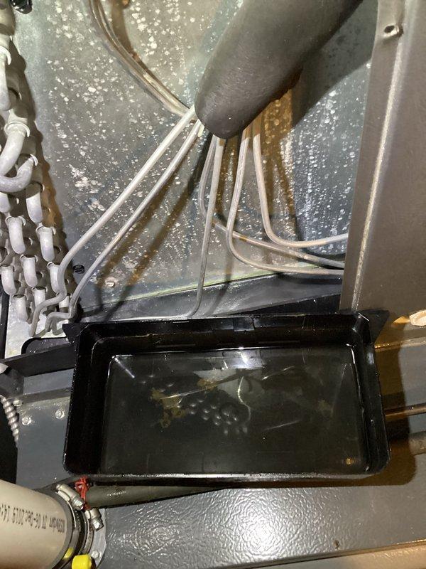 Completed annual AC tune-up and cooling system inspection on Energi Air unit. Observed significant condensation accumulation on air handler enclosure walls and multiple condensate drain lines with standing water in drain pan containing sediment buildup. Inspected condensate pump system, which showed dirt accumulation on housing and surrounding area but remained operational. All drainage components and PVC piping were verified for proper function to prevent water damage and ensure efficient moisture removal during cooling season.