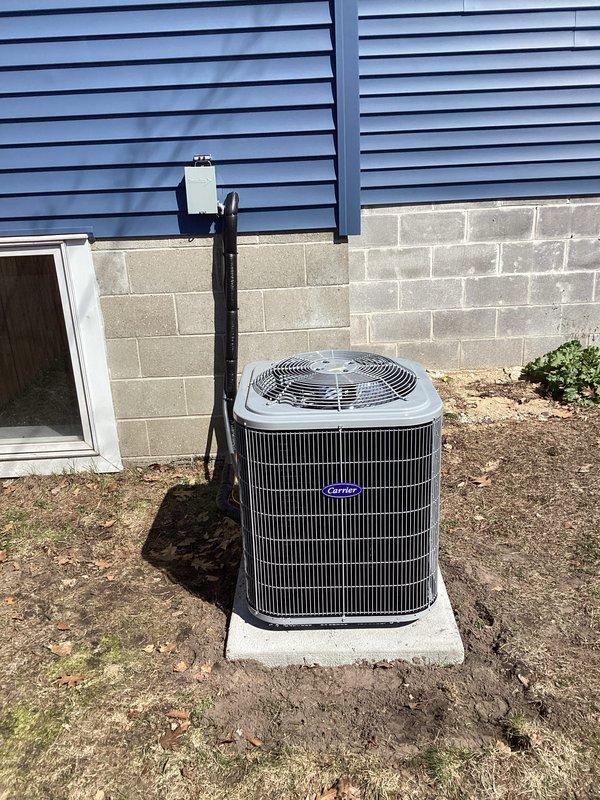 Successfully completed full HVAC system installation including new Carrier air conditioning condenser unit positioned on concrete pad with proper clearances from building exterior and ventilation louvers. Indoor installation included WeatherMaker 8000TS furnace with integrated air handler, complete ductwork connections utilizing galvanized metal supply ducts with properly sealed joints and elbows. All refrigerant lines, electrical conduit, and condensate drainage installed per manufacturer specifications. System tested and verified operational, with all safety labels and equipment documentation properly affixed.