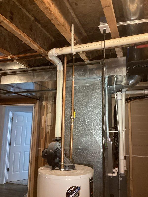 Provided estimate for replacement of 21-year-old Bradford White water heater located in unfinished basement utility area. Unit assessed with existing copper supply piping, expansion tank, and metal drip pan; documented current installation configuration including proximity to HVAC equipment and existing plumbing connections for replacement planning purposes.