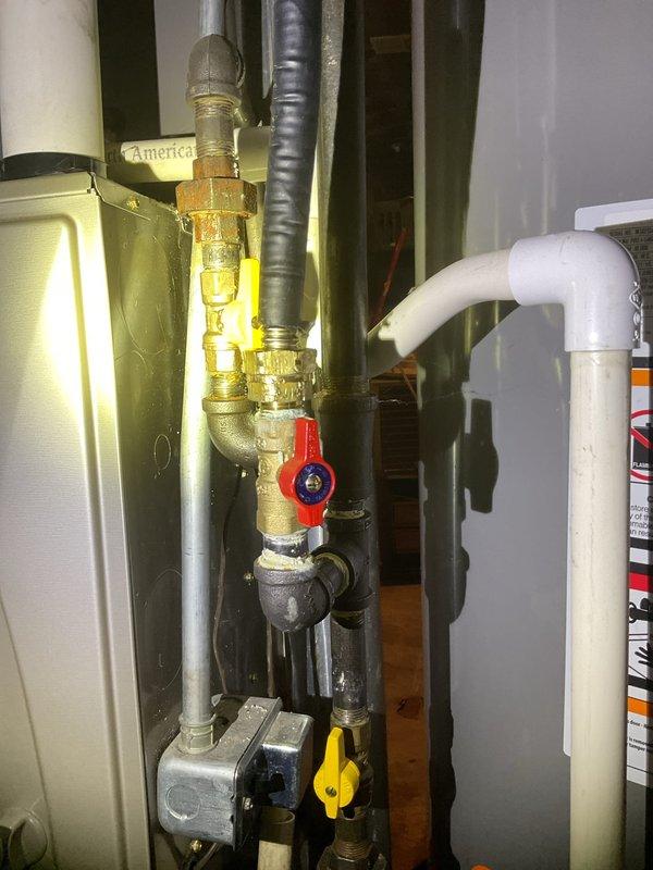 Responded to gas leak at washer/dryer location. Upon inspection, identified active gas leak in supply line servicing laundry appliances. Immediately shut off gas supply to affected area using isolation valve to ensure safety. Documented existing plumbing infrastructure including brass fittings, ball valves, and pressure relief components for future reference.