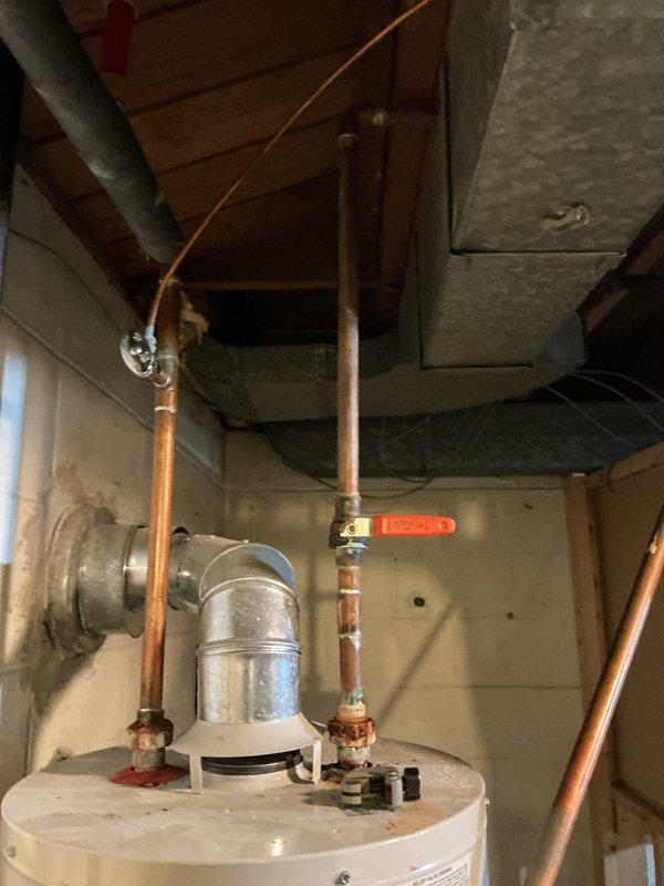 Completed installation of a 40-gallon Lochinvar natural gas water heater in basement utility area. Connected copper supply and discharge lines with proper shut-off valves, installed ventilation ductwork, and verified all connections for proper operation and safety compliance.