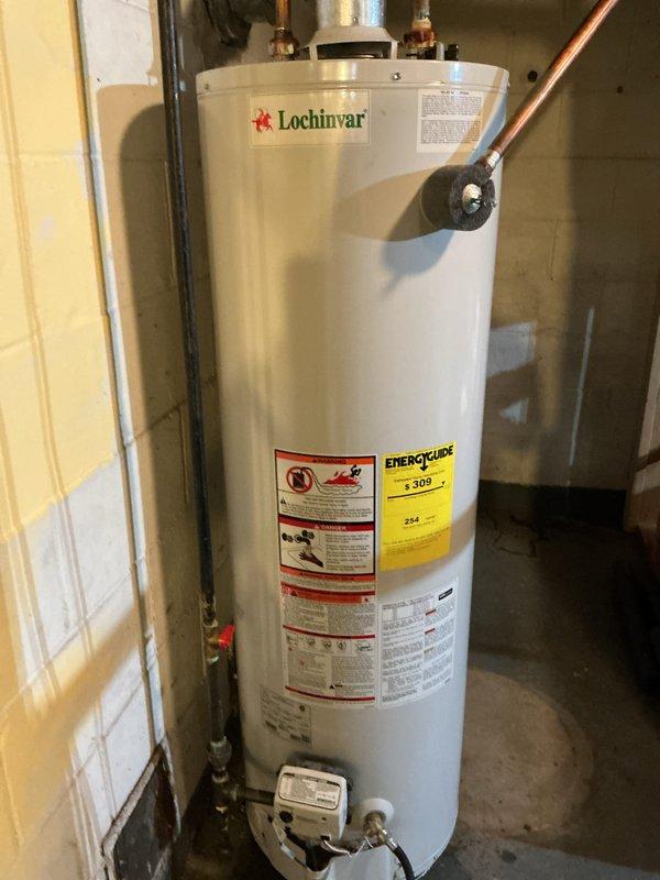 Completed installation of a 40-gallon Lochinvar natural gas water heater in basement utility area. Connected copper supply and discharge lines with proper shut-off valves, installed ventilation ductwork, and verified all connections for proper operation and safety compliance.