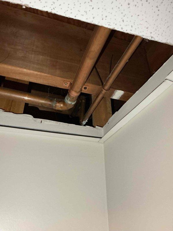 Responded to service call for continuously running toilet and exterior faucet leak penetrating into basement. Inspected toilet tank and identified faulty fill valve causing constant water flow. Accessed ceiling cavity to locate and assess exterior faucet supply line leaking through foundation into basement area. Documented plumbing configuration including copper pipe routing and connections. Replaced worn fill valve assembly and flapper mechanism to restore proper toilet function and eliminate running water issue. Addressed exterior faucet leak by tightening connections and evaluating pipe integrity where supply line enters structure, preventing further water intrusion into basement space.