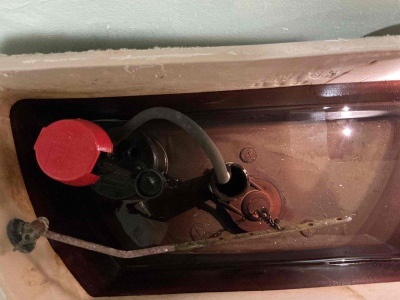Responded to service call for continuously running toilet and exterior faucet leak penetrating into basement. Inspected toilet tank and identified faulty fill valve causing constant water flow. Accessed ceiling cavity to locate and assess exterior faucet supply line leaking through foundation into basement area. Documented plumbing configuration including copper pipe routing and connections. Replaced worn fill valve assembly and flapper mechanism to restore proper toilet function and eliminate running water issue. Addressed exterior faucet leak by tightening connections and evaluating pipe integrity where supply line enters structure, preventing further water intrusion into basement space.