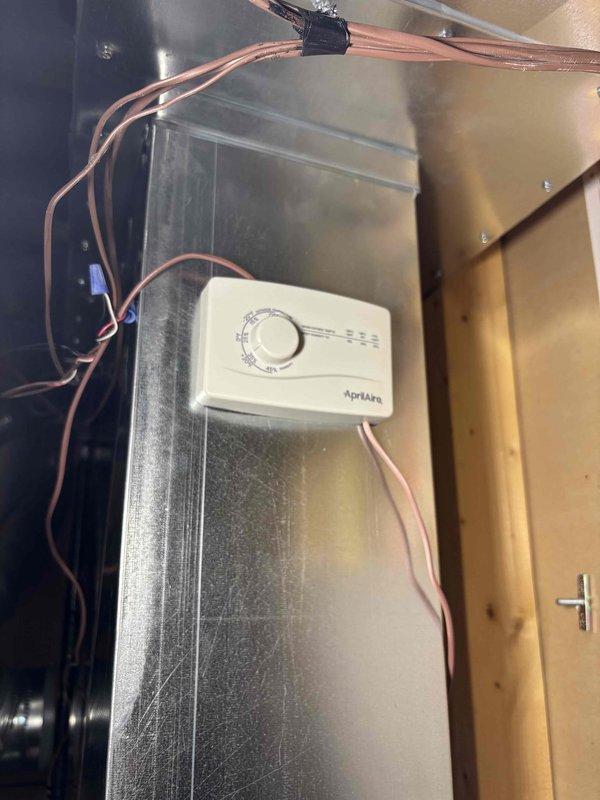 Completed installation of AprilAire whole-home humidifier integrated into existing HVAC ductwork system. Mounted humidifier control unit on main supply plenum with proper wiring connections, installed water supply line with saddle valve, and configured humidity settings for optimal performance. System tested and operational, providing automated humidity control throughout the residence.