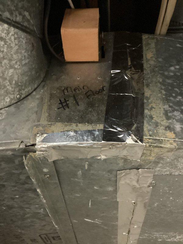 Completed annual cooling maintenance on two one-year-old air conditioning systems. Performed comprehensive inspection of both units including filter replacement, coil cleaning, refrigerant level verification, electrical connection testing, and condensate drain line flushing. Inspected basement-mounted Aprilaire humidifier unit with associated ductwork and plumbing connections, confirming proper operation and secure mounting. Accessed attic space to inspect main supply ductwork labeled "Main #1 Back," verified all duct connections are sealed and insulation is intact. Both AC systems operating within manufacturer specifications with no deficiencies noted. All components tested and confirmed functional for the cooling season.