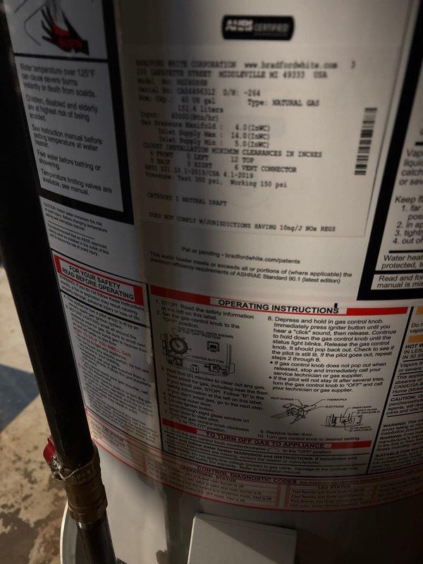 Completed full water heater replacement in basement utility area, removing existing unit and installing new Bradford White natural gas water heater. Connected all copper supply and discharge piping with proper fittings and joints, installed black flexible exhaust venting from top of unit, and verified all connections for proper operation and code compliance. Unit tested successfully with no leaks detected and all safety labels intact.
