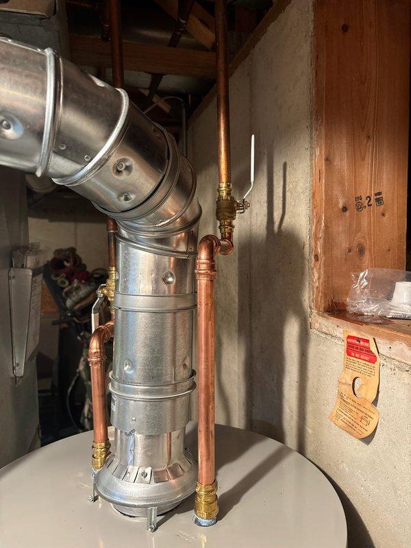 Installed a 40-gallon natural gas Bradford White water heater in basement utility room. Connected copper supply lines with brass shut-off valves, installed metallic vent pipe with proper exhaust routing, and positioned unit on drain pan per manufacturer specifications. All safety labels and operating instructions verified, system tested and operational.