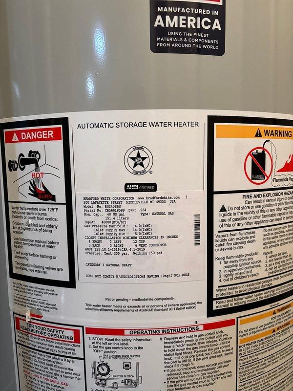Installed a 40-gallon natural gas Bradford White water heater in basement utility room. Connected copper supply lines with brass shut-off valves, installed metallic vent pipe with proper exhaust routing, and positioned unit on drain pan per manufacturer specifications. All safety labels and operating instructions verified, system tested and operational.