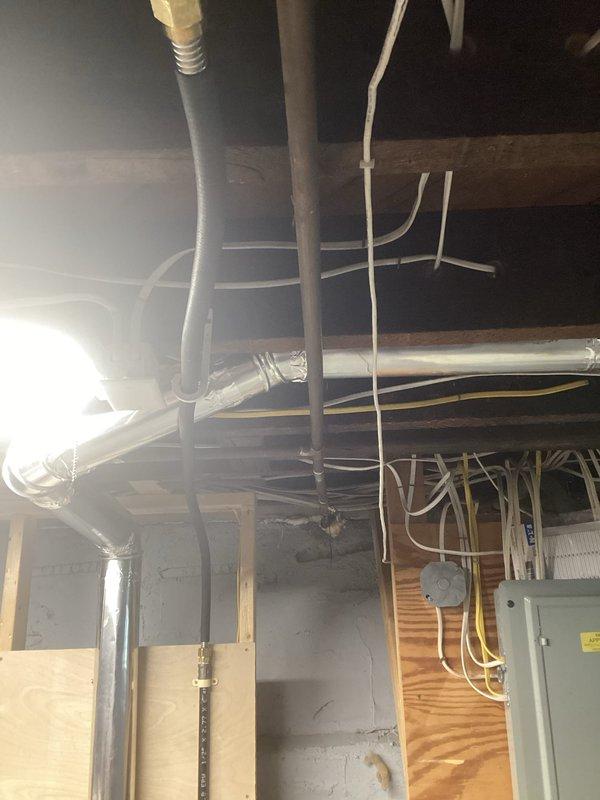 Completed installation of gas line for dryer in unfinished basement area. Routed new gas piping through existing utility infrastructure alongside electrical conduit, PVC plumbing, and HVAC ductwork between exposed ceiling joists. Installation performed in accordance with local codes and safety standards, with proper securing and support of gas line throughout the run.