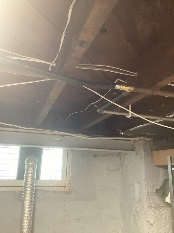 Completed installation of gas line for dryer in unfinished basement area. Routed new gas piping through existing utility infrastructure alongside electrical conduit, PVC plumbing, and HVAC ductwork between exposed ceiling joists. Installation performed in accordance with local codes and safety standards, with proper securing and support of gas line throughout the run.