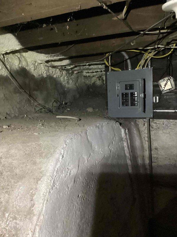 Conducted site assessment for whole house generator installation with automatic transfer switch. Inspected existing electrical infrastructure in basement area, documenting current electrical panel configuration, circuit breaker locations, and available wiring pathways along floor joists. Photographed utility space layout, concrete foundation walls, and exposed mechanical systems to determine optimal generator placement and transfer switch integration points for future installation planning.