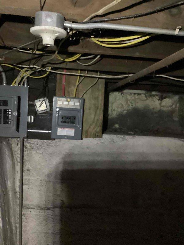 Conducted site assessment for whole house generator installation with automatic transfer switch. Inspected existing electrical infrastructure in basement area, documenting current electrical panel configuration, circuit breaker locations, and available wiring pathways along floor joists. Photographed utility space layout, concrete foundation walls, and exposed mechanical systems to determine optimal generator placement and transfer switch integration points for future installation planning.