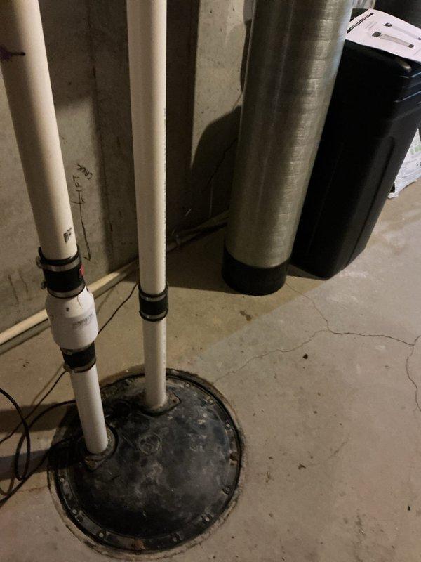 Replaced battery backup sump pump and sewage ejector pump system in basement utility area. Installed new pumps with associated PVC discharge piping, electrical connections, and basin components to restore proper water management and sewage handling functionality.