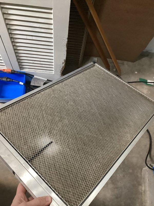 Completed annual cooling maintenance on EnergiAir system per 3-year service agreement. Inspected and photographed moderately soiled air filter showing accumulated dust and debris, indicating normal system operation since last service. Checked condensate drain pan for proper drainage and debris accumulation, finding unit in satisfactory operating condition with no immediate service needs identified.