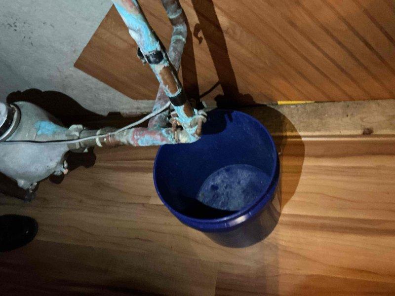 Replaced approximately 5 feet of deteriorated copper water line from the meter to the saddle valve. The existing pipe showed significant corrosion and material degradation at multiple connection points, requiring complete removal and replacement. New copper piping was installed to restore proper water flow and eliminate active leaking in the utility area near the water softener system.