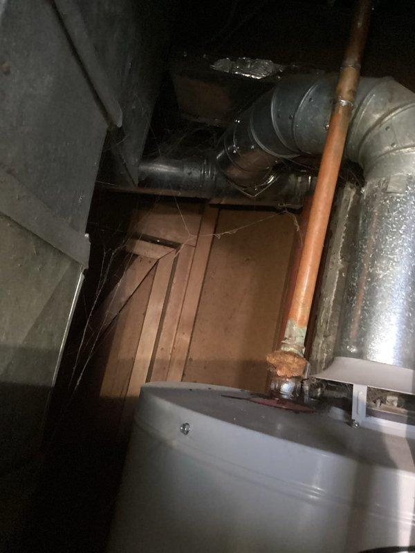 Responded to water heater failure following basement flooding incident. Upon arrival, inspected 15-year-old A.O. Smith water heater unit for water damage and operational status. Evaluated electrical connections, gas supply lines, copper piping, shut-off valves, and flue venting system for flood-related damage or debris. Assessed pilot light, thermocouple, and burner assembly functionality. Documented equipment condition with photographs showing water heater installation, surrounding utility area, and associated plumbing connections. Verified proper venting and clearances around unit. Customer advised of findings and unit restored to working order.