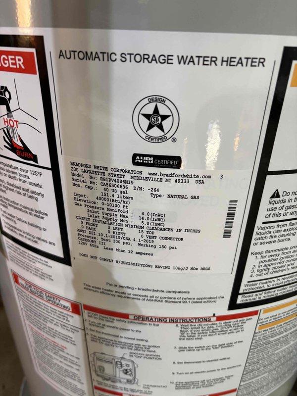 Installed a Bradford White 40-gallon automatic storage water heater with 60,000 BTU/h capacity in basement utility area. Connected copper supply lines with brass fittings to unit inlet/outlet, installed black expansion tank on vertical piping, and established proper clearances to combustibles per manufacturer specifications. Verified all gas connections, tested unit operation, and confirmed proper venting and safety controls were functioning correctly.