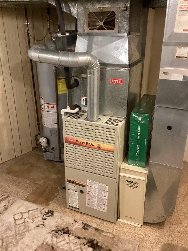 Completed estimate for water heater replacement in residential basement mechanical room. Assessed existing A.O. Smith water heater installation alongside Plus 80v furnace system, documented current configuration including copper piping connections, venting arrangement, and clearance specifications. Photographed equipment layout and provided replacement options for homeowner consideration.