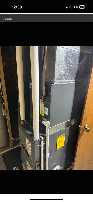 Completed warranty furnace unit replacement in residential utility closet, installing new vertical air handler system with evaporator coil assembly. Configured PVC condensate drain lines, connected refrigerant lines and electrical conduits, and integrated ductwork to existing HVAC infrastructure within confined mechanical space.