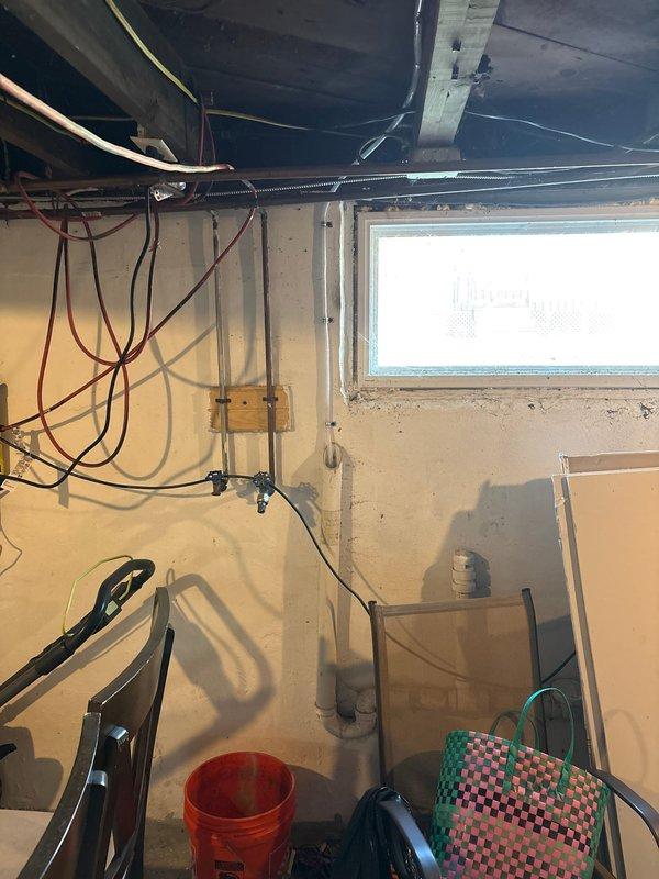 Successfully completed add-on air conditioning system installation to existing heating infrastructure. Integrated new AC unit with existing Carrier furnace system in basement utility closet, including refrigerant line installation, electrical connections, and condensate drain routing. Installed flexible ductwork connections to interface with existing duct system, ran necessary refrigerant piping through basement area with proper support and insulation, and completed all electrical wiring per code requirements. System tested and verified operational, with proper airflow and cooling capacity confirmed.