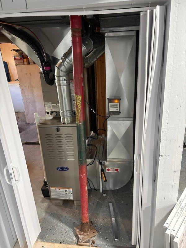 Successfully completed add-on air conditioning system installation to existing heating infrastructure. Integrated new AC unit with existing Carrier furnace system in basement utility closet, including refrigerant line installation, electrical connections, and condensate drain routing. Installed flexible ductwork connections to interface with existing duct system, ran necessary refrigerant piping through basement area with proper support and insulation, and completed all electrical wiring per code requirements. System tested and verified operational, with proper airflow and cooling capacity confirmed.