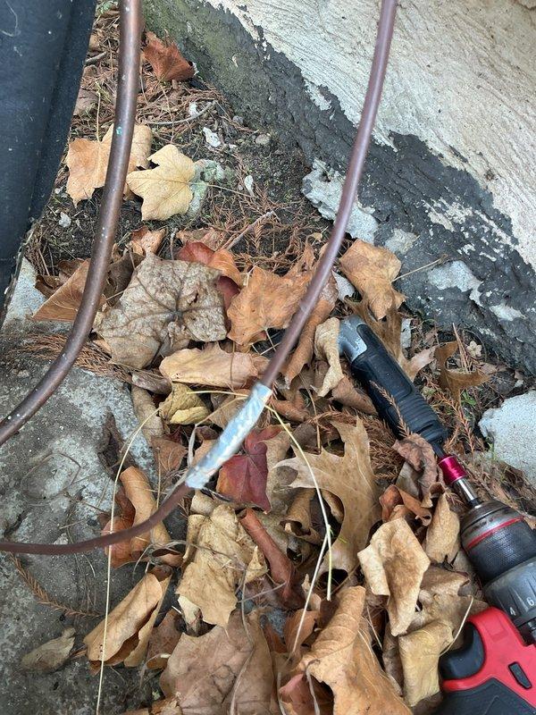 Completed annual cooling system tune-up and maintenance inspection on residential AC unit. Serviced outdoor condenser unit, including cleaning of accumulated debris (leaves and organic matter) from around foundation and equipment area. Inspected electrical disconnect box, refrigerant line sets, copper piping, conduit runs, and insulated suction lines for proper operation and connection integrity. All components found to be functioning within normal parameters, with electrical connections secure and refrigerant lines properly insulated. Unit is operating efficiently and ready for cooling season.