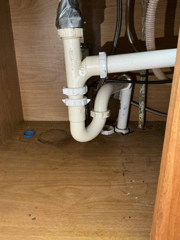 Responded to service call for water leaking above water heater and potential under-sink leak. Inspected Richmond water heater and identified issue with temperature and pressure relief valve requiring repair, along with water supply line connection that needed attention. Examined under-sink plumbing configuration including P-trap assembly, drain connections, and supply lines to assess previous repair work and current leak concerns. Documented all plumbing components and conditions with photographs for client approval of necessary repairs.