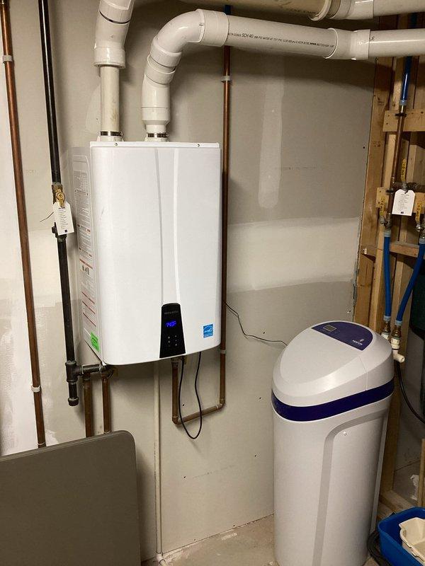 Completed annual cooling maintenance on 9-year-old Trane XR series air conditioning system. Performed comprehensive tune-up including inspection of outdoor condenser unit, verified proper airflow through louvers, checked fan operation, and confirmed unit is operating within normal parameters. Documentation photos captured of condenser unit exterior condition and basement mechanical equipment area showing proper installation and system integration with tankless water heater and water softener. System tested and found to be functioning properly with no immediate repairs required.