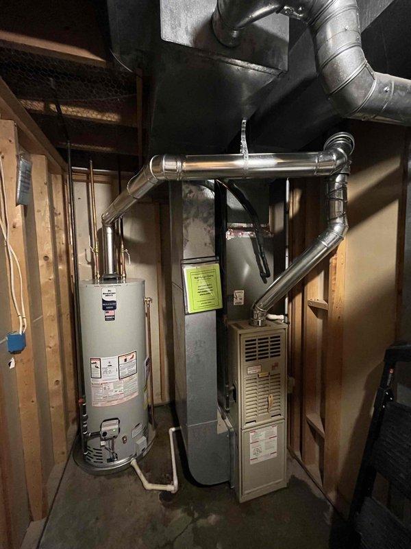 Responded to no hot water complaint and discovered active leak on 15-year-old Bradford White water heater. Verified pilot light operation, inspected pipe connections which were in good condition, and confirmed tank failure requiring complete unit replacement. Provided estimate for new water heater installation.