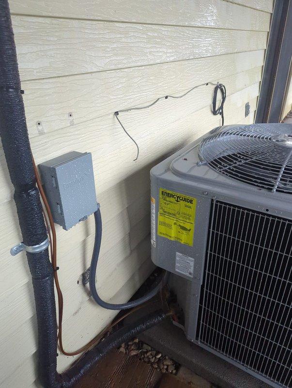 Responded to inspection correction request for missing condenser service valve caps. Documented outdoor HVAC unit installation with detailed photographs showing refrigerant line connections, brass service valves, electrical disconnect, and overall system configuration to provide visual evidence of current installation status for inspector review and approval.