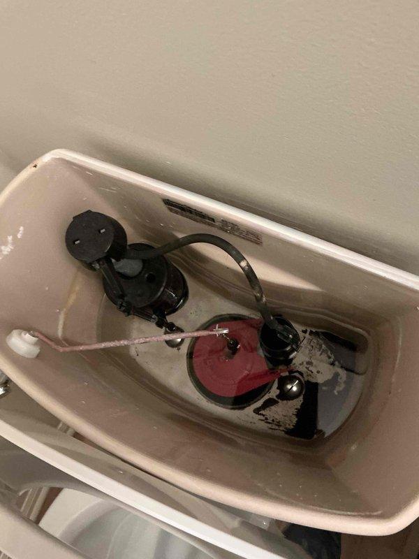 Responded to low water pressure and incomplete flushing issue in downstairs guest bathroom toilet. Inspected tank components and found low water level with mineral buildup on internal surfaces. Verified flush valve, flapper, and fill valve operation. Adjusted fill valve to restore proper water level in tank, ensuring adequate flush pressure. Tested flush mechanism multiple times to confirm complete bowl evacuation on first flush. Toilet now operating within normal parameters.